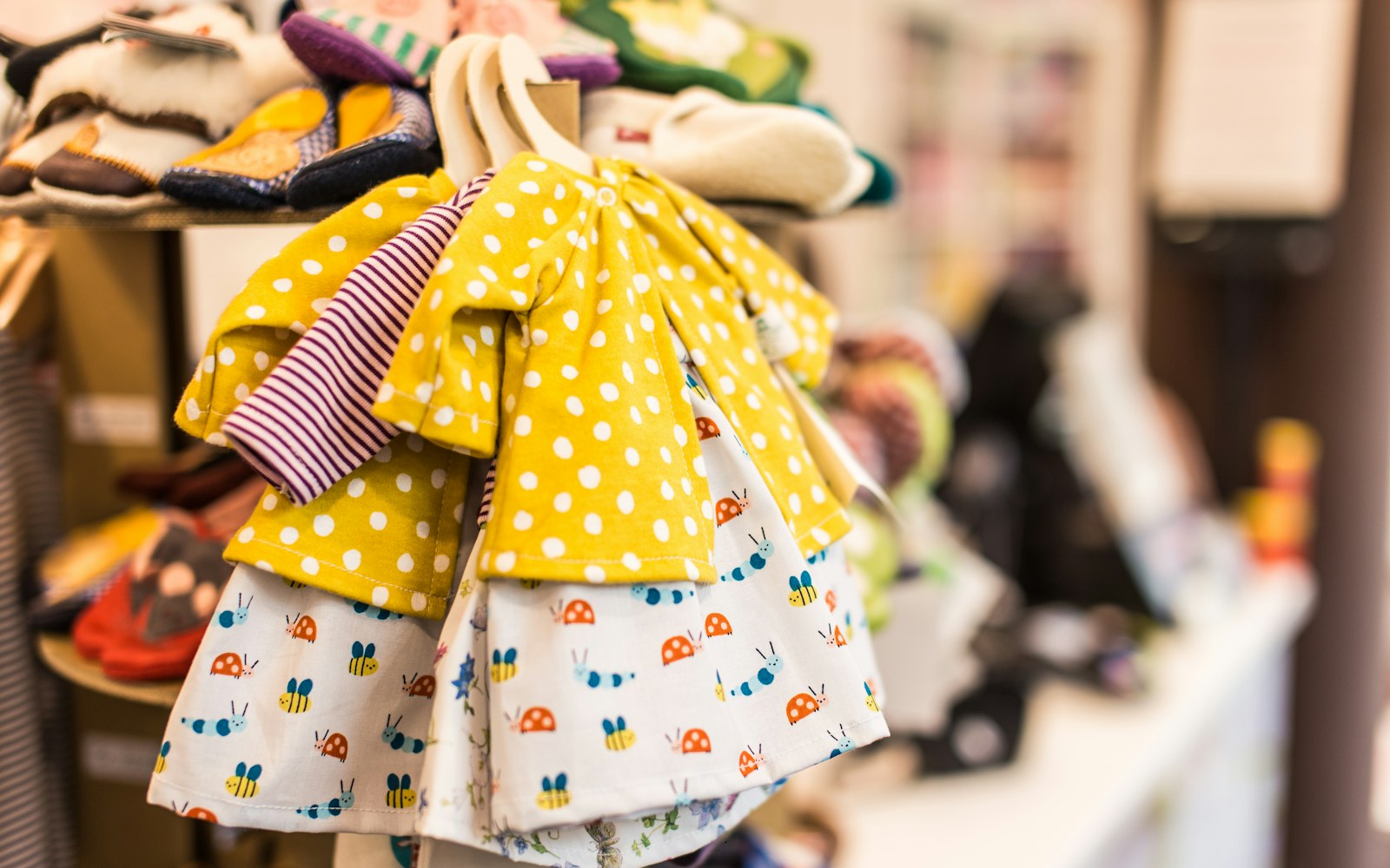 Small-scale dressmaking tools and fluid fabric arranged beside an articulated art doll