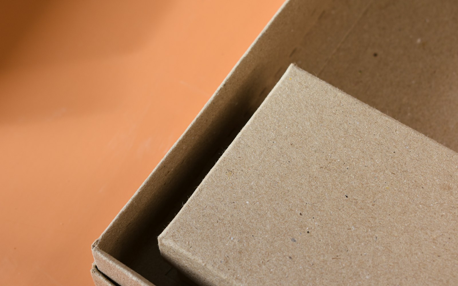 A handmade mixed-media art doll resting in a padded storage box with tissue, labeled accessory containers, and soft custom supports.