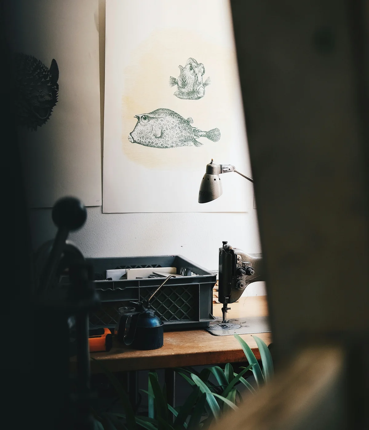 A sewing machine and artwork in a quiet studio.